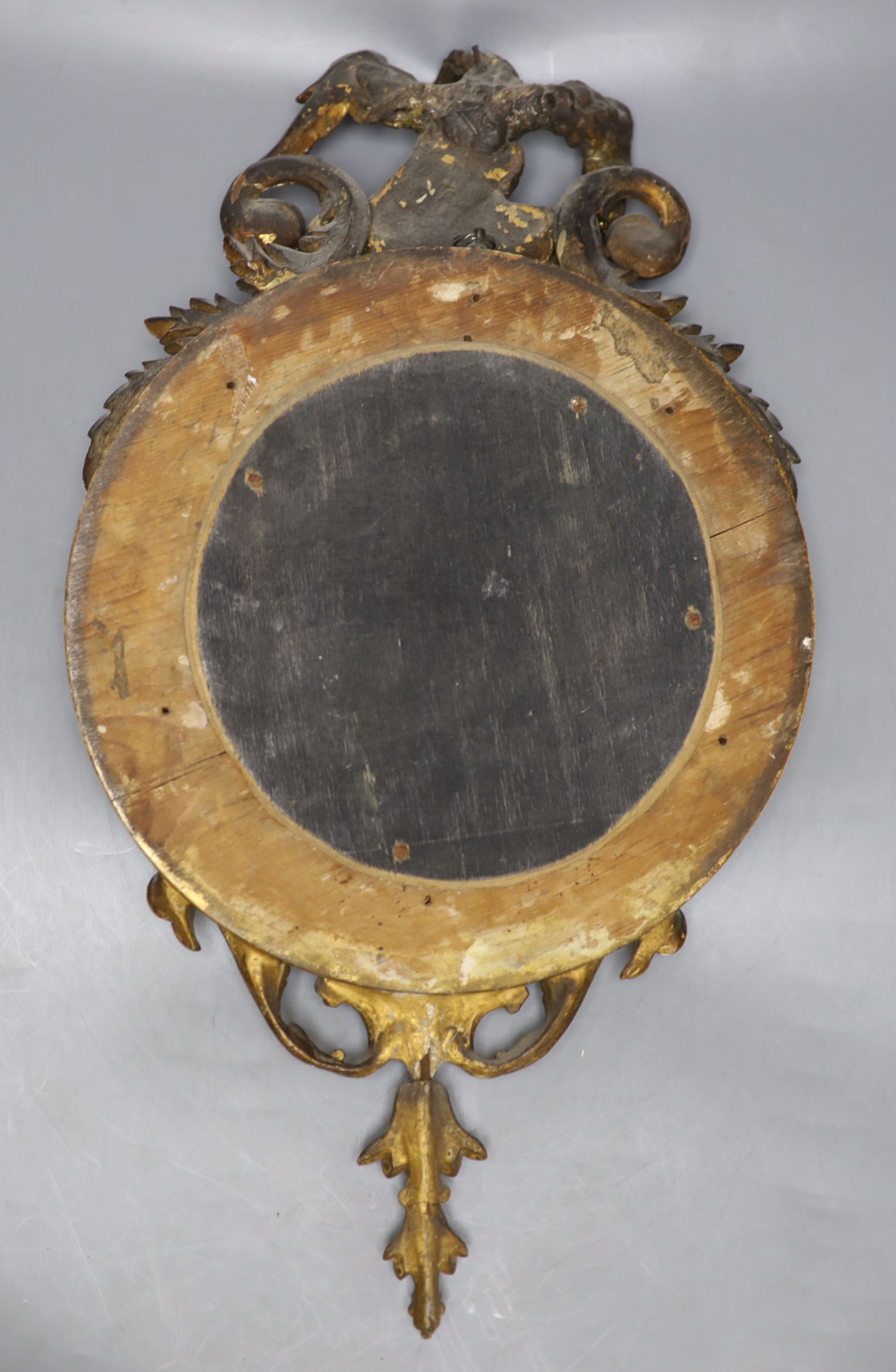 A small Regency style giltwood and gesso convex wall mirror, overall length 49cm